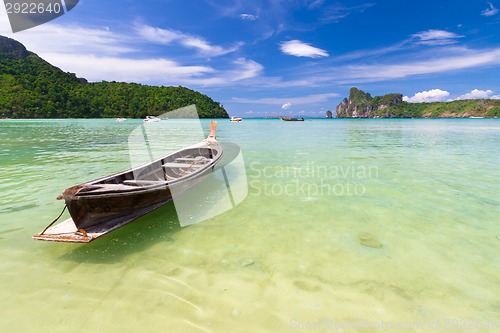 Image of Wooden boat on a tropical beach.