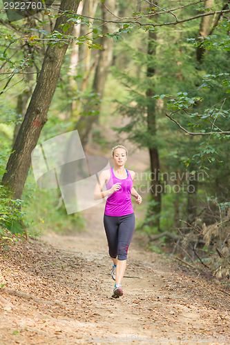 Image of Pretty young girl runner in the forest. 