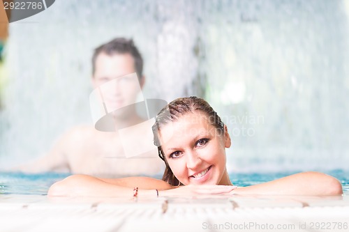 Image of Young couple in the swimming pool.