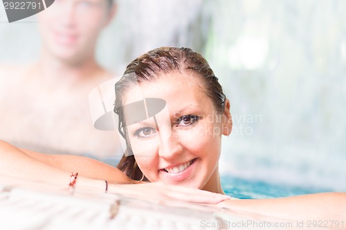 Image of Young couple in the swimming pool.