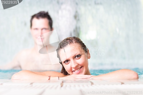 Image of Young couple in the swimming pool.