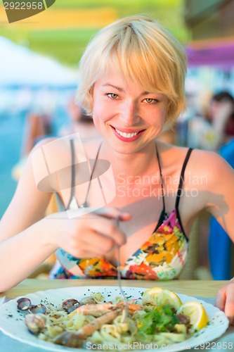 Image of Woman eating healthy food.