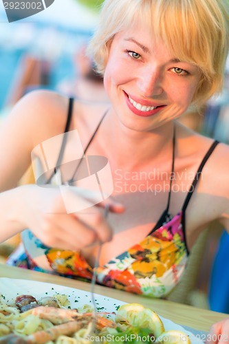 Image of Woman eating healthy food.