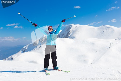 Image of Excited woman skier.