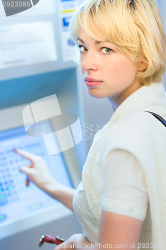 Image of Lady buying a ticket at the vending machine