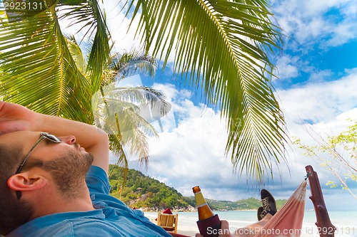 Image of Man relaxing on a tropical beach.