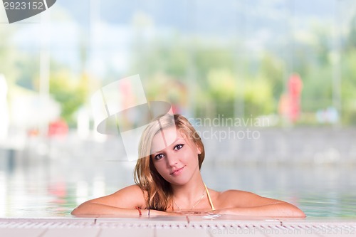 Image of Young woman in the swimming pool.