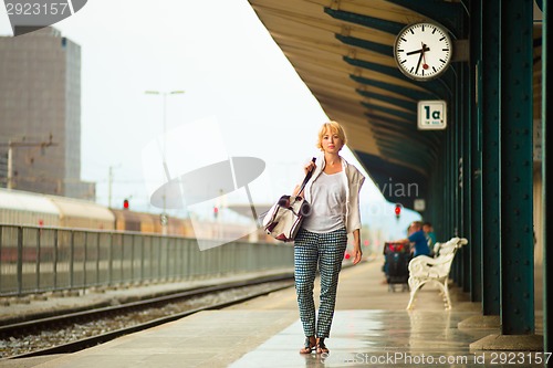 Image of Lady waiting at the railway station.