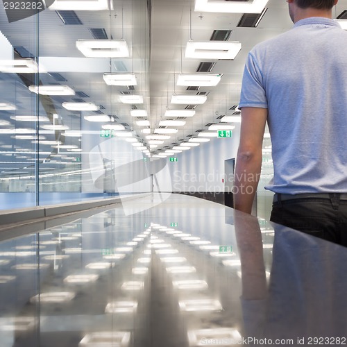 Image of Business travelers in airport terminal hall.