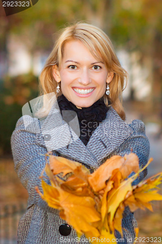 Image of Lady with autumn leaves.