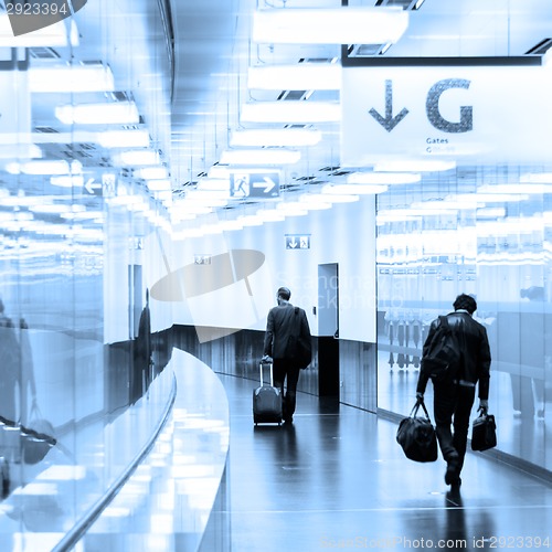 Image of Business travelers in airport terminal hall.