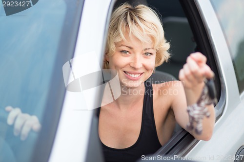 Image of Lady, driving showing car keys out the window.