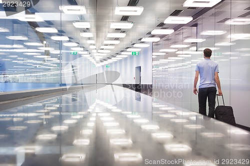 Image of Business travelers in airport terminal hall.