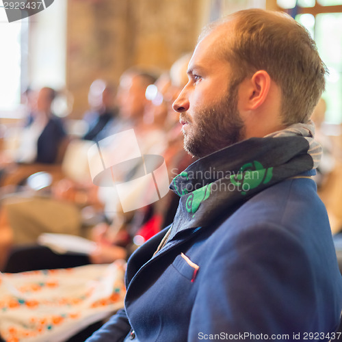 Image of Entrepreneur in audience at business conference.