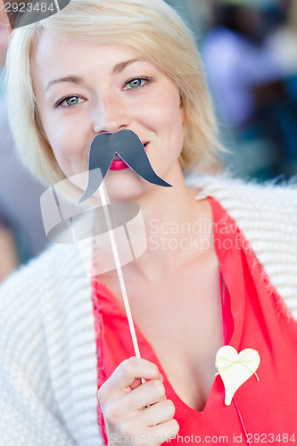 Image of Woman with fake mustache.