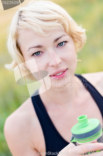 Image of Portrait of woman drinking water outdoor