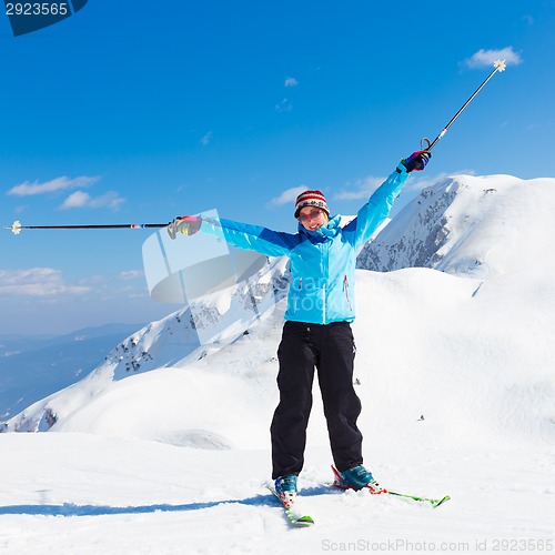 Image of Excited woman skier.