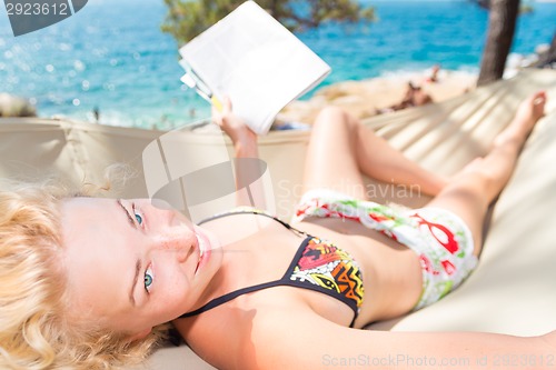 Image of Beautiful girl lies on hammock on the beach