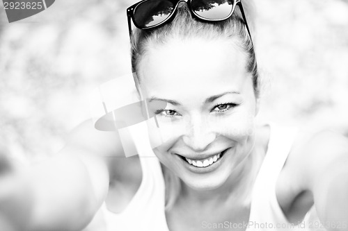 Image of Black and white portrait of a cheerful young woman.