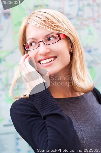 Image of Beautiful woman talking by cell phone
