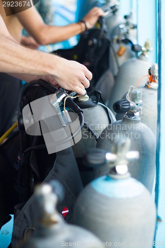 Image of Guy checking the diving equipment.