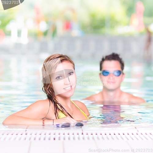 Image of Young couple in the swimming pool.