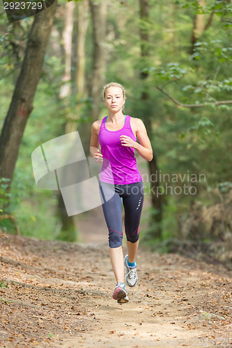 Image of Pretty young girl runner in the forest. 
