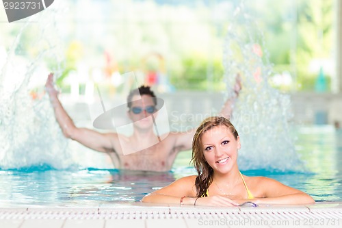 Image of Young couple in the swimming pool.