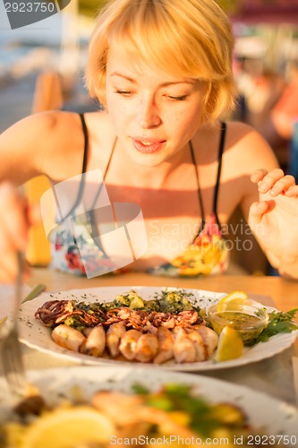 Image of Woman eating healthy food.