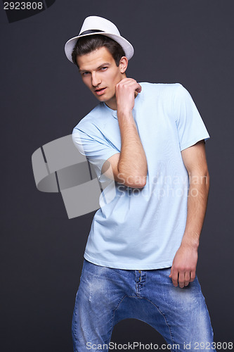 Image of Handsome man in blank blue t-shirt and fedora hat