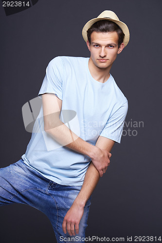 Image of Handsome man in blank blue t-shirt and fedora hat