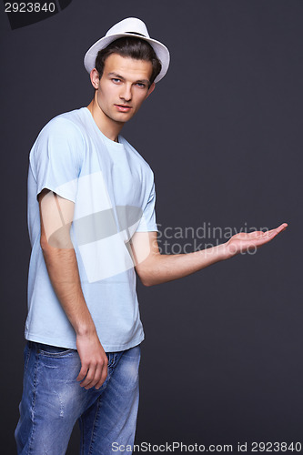 Image of Stylish man showing open hand palm with copy space