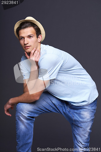Image of Thinking man leaning on his knee