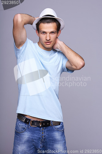 Image of Man standing posing with hat