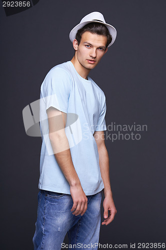Image of Handsome man in blank blue t-shirt and fedora hat