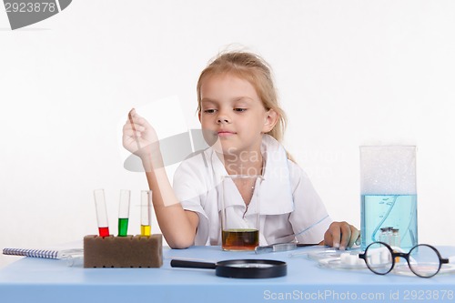 Image of Chemist selects reagent in a test tube