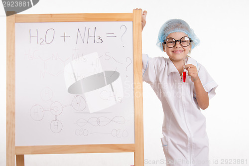 Image of Pharmacist standing at the blackboard with a test tube