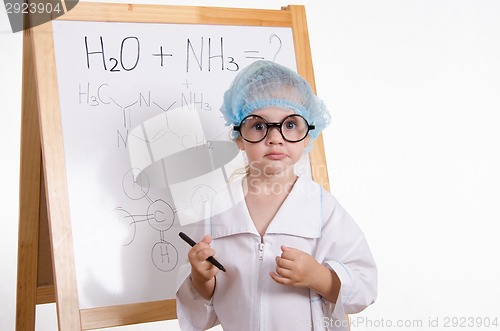 Image of Chemist with a marker at the blackboard