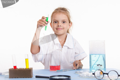 Image of Chemist with green liquid in a test tube