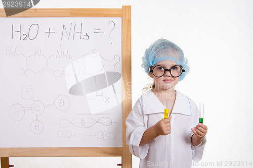 Image of Chemist in points and with two tubes at board