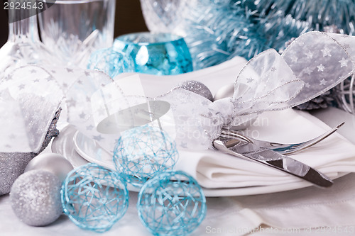 Image of Stylish blue and silver Christmas table setting