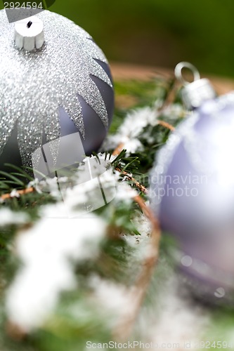 Image of Silver Christmas ornaments in leaves