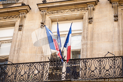 Image of Flag of France fluttering under a serene blue sky