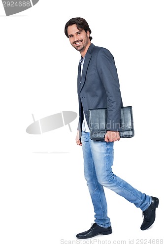 Image of Handsome stylish man carrying a briefcase