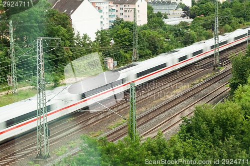 Image of Fast moving train with red stripe