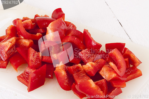 Image of Pile of Chopped Red Pepper on Cutting Board