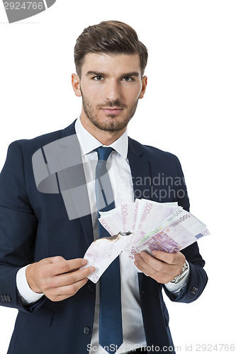 Image of Wealthy successful businessman burning money