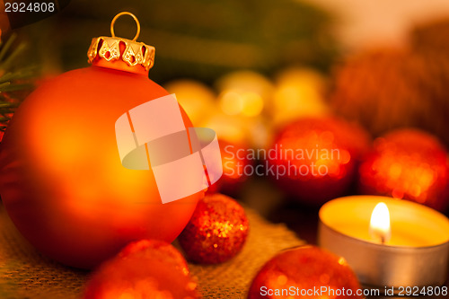 Image of Warm gold and red Christmas candlelight background