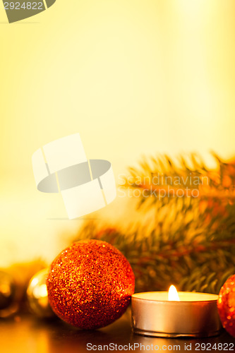 Image of Warm gold and red Christmas candlelight background