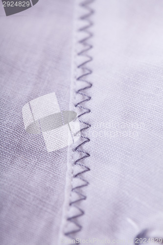 Image of Closeup Small Buttons on White Cloth